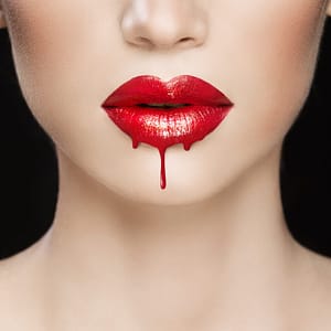 Vampire roleplay illustration close up of pale woman's face from nose to neck with dripping gloss red lips to suggest a vampire